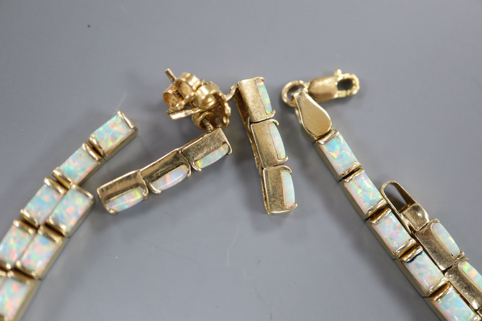 A modern stylish 750 yellow metal and white opal set necklace and pair of matching drop earrings,